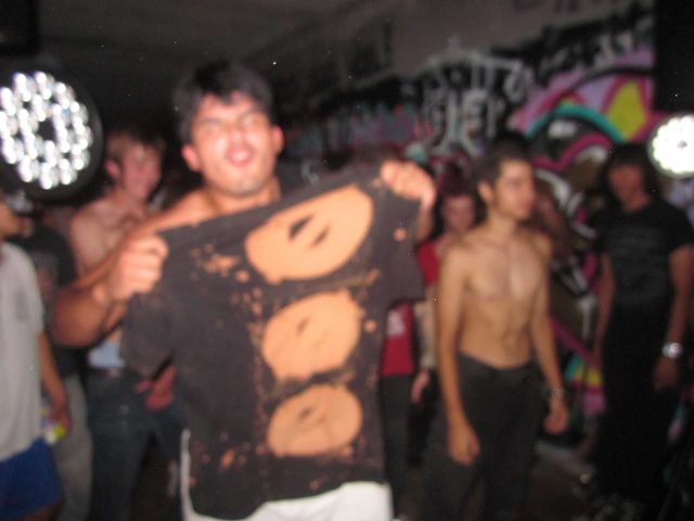 Fan holding a SERATONIN shirt in the crowd
